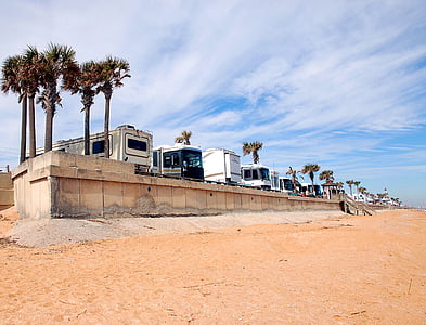 five camper shells near seashore under blue sky thumbnail