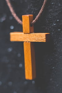 Brown Wooden Cross Pendant on Closeup Photography thumbnail