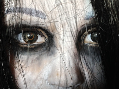 person with black mascara close up photo thumbnail