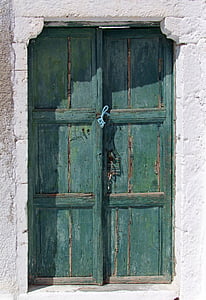 closed two teal wooden 3-panel doors thumbnail