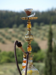 shallow focus photography of brass and black hookah during daytime thumbnail