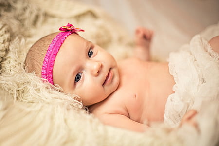 baby wearing pink headband thumbnail