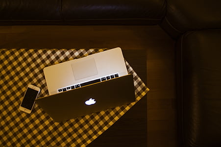 silver MacBook turned on on top of table thumbnail
