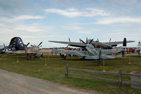 assorted-color planes on grass field at daytime thumbnail