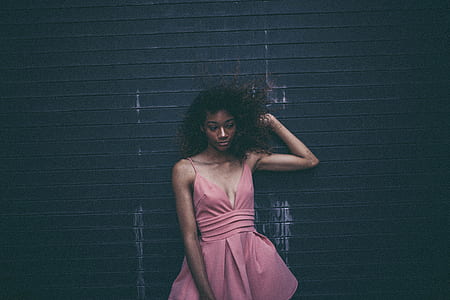 woman leaning on black striped wall thumbnail