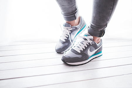 person wearing gray-and-white Nike running shoes thumbnail
