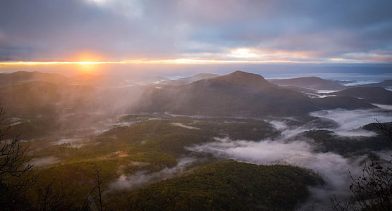 aerial photography of mountains under white clouds during daytime thumbnail