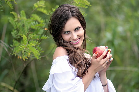 woman holding apple fruit wearing white off-shoulder blouse thumbnail