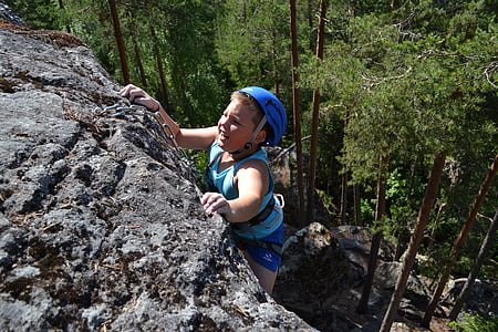 boy climbing rock cliff thumbnail