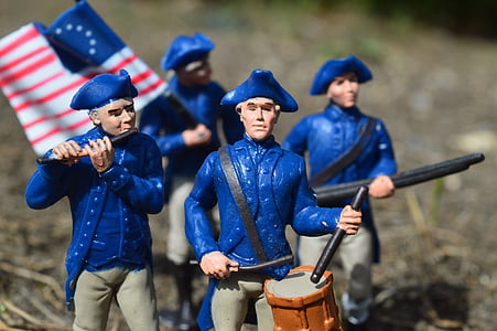 tilt shift lens photography of four soldiers plastic figures thumbnail