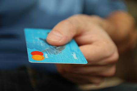 person holding blue MasterCard credit card thumbnail