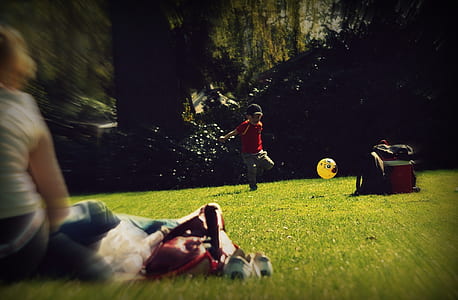 boy playing on green grass field thumbnail