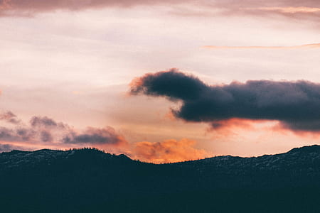 silhouette of mountain under blue and white sky thumbnail