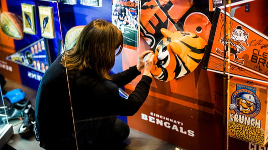 woman wearing black shirt fixing artwork thumbnail