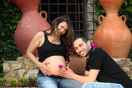 pregnant woman sitting beside man during daytime thumbnail