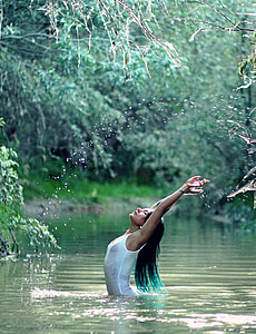 photography of woman stretching her hands while in the body of water thumbnail