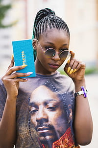 Woman in Black Tee Shirt Holding Blue Case thumbnail