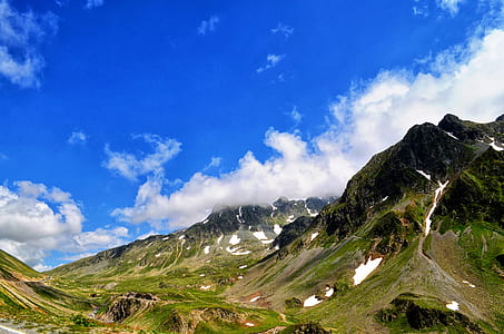time lapse photography of clouds over hill thumbnail
