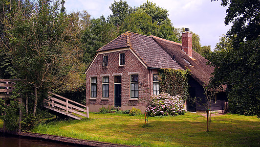 brown wooden house surrounded with trees thumbnail