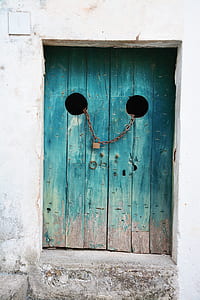 brown metal chain with lock on blue door thumbnail