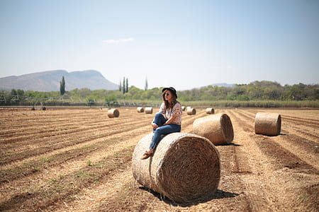 woman sitting on bale of hay thumbnail