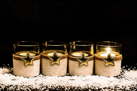 four lighted clear candle holders thumbnail