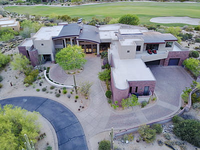 aerial photography of concrete building with grass field thumbnail