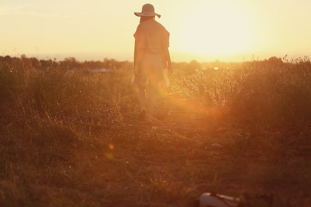 person walking in the grass field thumbnail
