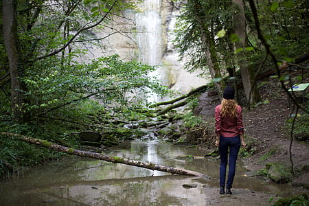 woman standing beside lake with trees thumbnail
