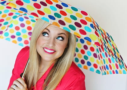 woman wearing red dress holding multicolored folding umbrella thumbnail