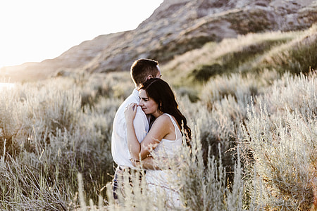 couple stands beside grass thumbnail