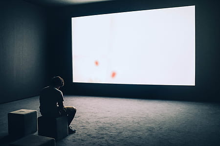man sitting on chair inside room thumbnail