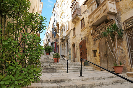 gray concrete stairs with black handrail during daytime thumbnail