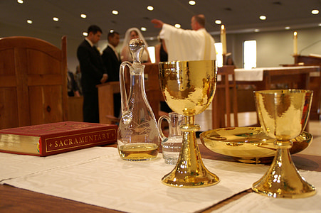 gold-colored chalices on table near sacramentary book thumbnail