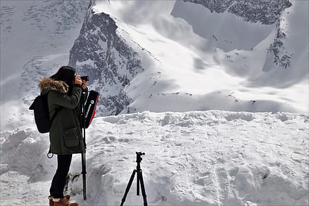 woman taking picture on white snow sand thumbnail