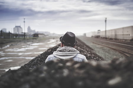 shallow focus photography of man wearing black fedora hat thumbnail