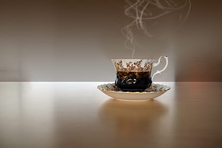 white-and-black ceramic teacup on saucer thumbnail