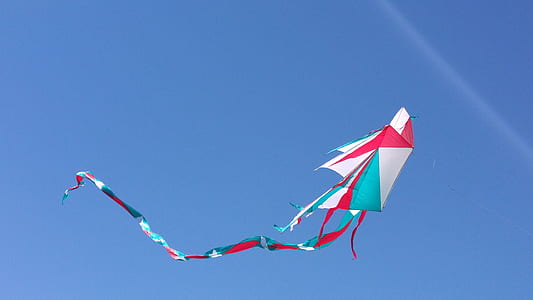 red, white, and green kite flying on mid air during daytime thumbnail
