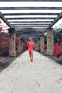 woman  in red scoop-neck long-sleeved mini dress standing on pathway thumbnail