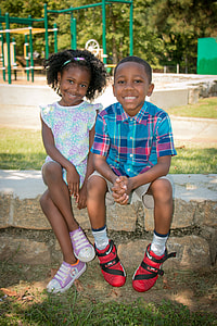 boy and girl sitting next to each other thumbnail