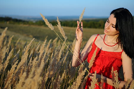 woman holding brown rice grains during daytime thumbnail