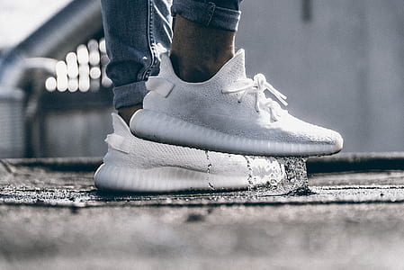 person wearing cream white adidas yeezy boost 350 V2 standing on water thumbnail