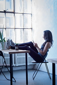 Woman Sitting On Black Folding Chair thumbnail