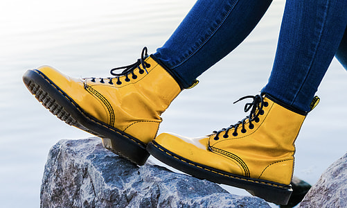 person wearing pair of yellow leather boots thumbnail