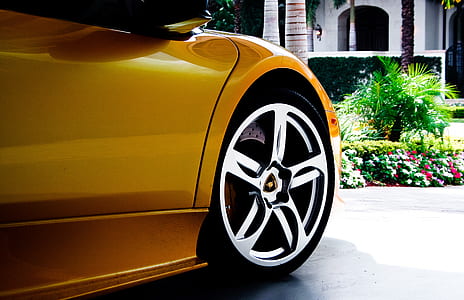yellow sports coupe parked on concrete ground thumbnail