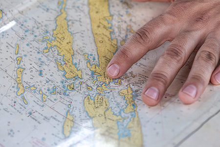 person touching white and yellow map thumbnail