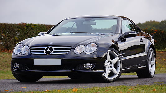 black Mercedes-Benz coupe on road at daytime thumbnail