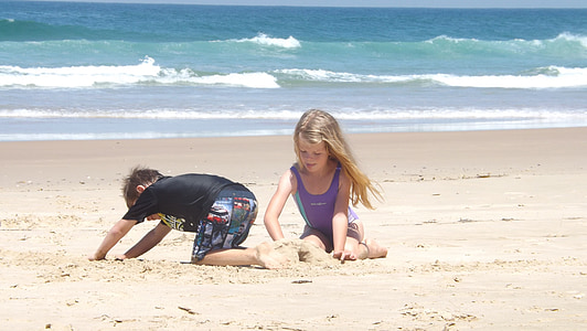 photography of boy and girl on beach thumbnail