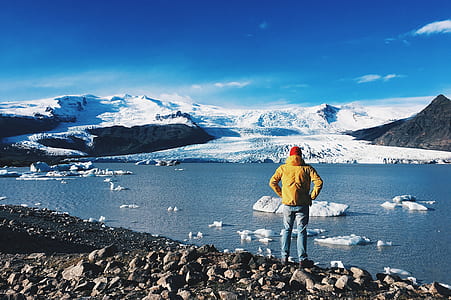 man standing near body of water thumbnail