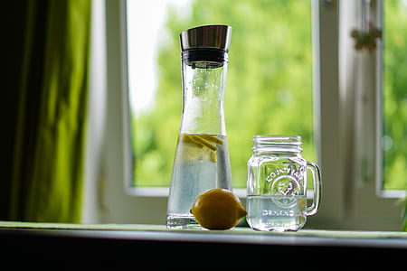 clear glass bottle beside jar thumbnail